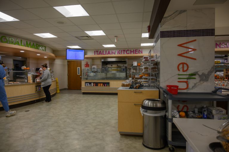 A customer is served at the Italian Kitchen counter in a cafeteria.